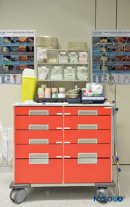 Equipment storage cart with clear identification of supplies and medication.